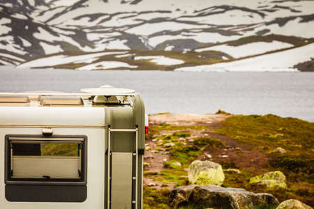 Tourism vacation and travel. Camper van motorhome on camping site rest place in norwegian mountainsの写真素材