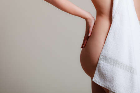 Sensuality and sexuality of women. Perfect female part body covered by bath towel. Seductive woman with naked sexy ass.の写真素材