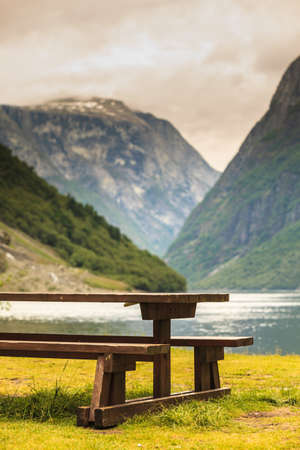 Picnic site wooden table and benches in norwegian nature, Europe.の写真素材