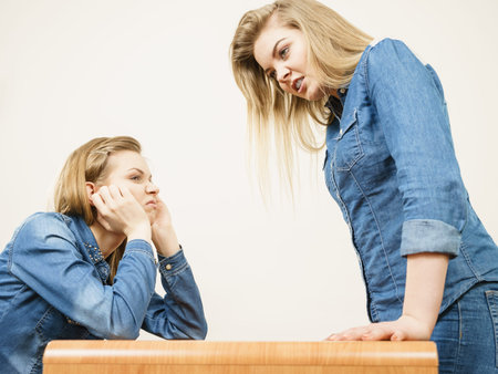 Two women having argue mocking up being mad at each other. Female telling off, ignorance concept.