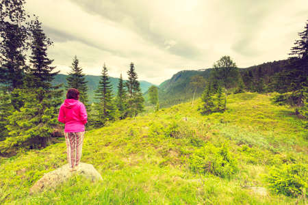 Tourism vacation and travel. Tourist woman enjoying mountains landscape at summer in Norway, Scandinavia.の写真素材