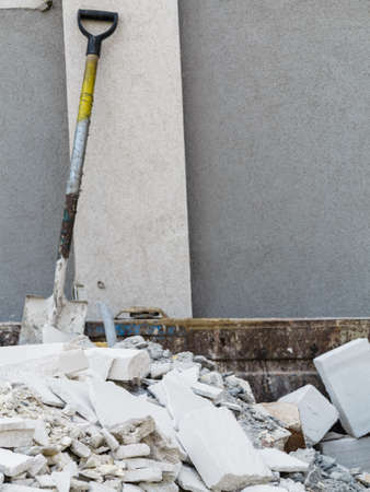 Full construction waste debris container, garbage bricks and material from demolished houseの写真素材