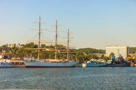 Naval maritime sea warship oldschool concept. Ships anchored at dock. Sailing schooner and destroyer...