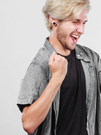Success positive emotion concept. Young college student, happy young successful man clenching fist...
