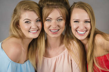 Happy positive female friends having fun enjoying their feminine leisure time. Friendship concept.の写真素材