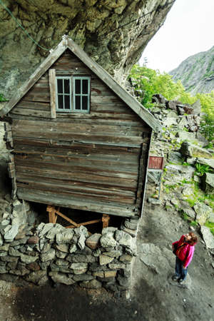 Tourist woman visiting the Helleren houses in Jossingfjord along road 44 between Egersund and Flekkefjord, Sokndal municipality, Norway.の写真素材