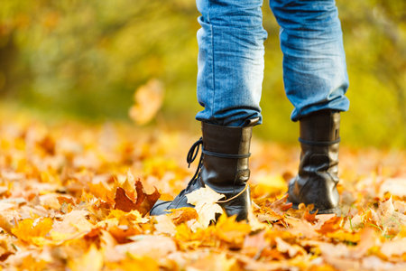 Nature outdoor foliage relax concept. Man in black boots.  Male in leather footwear jeans trousers...