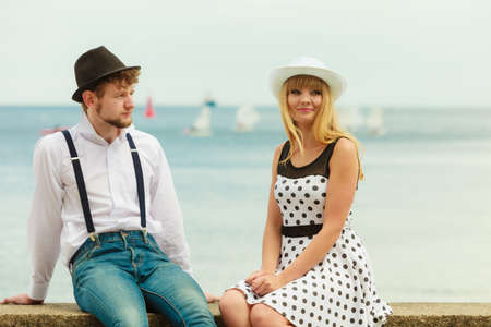 Summer holidays love relationship and dating concept - romantic playful couple retro style flirting on sea shoreの写真素材