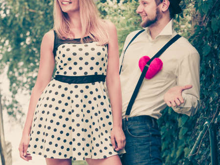 Summer holidays love relationship and dating concept - romantic happy couple retro style with red heart love symbol outdoorの写真素材