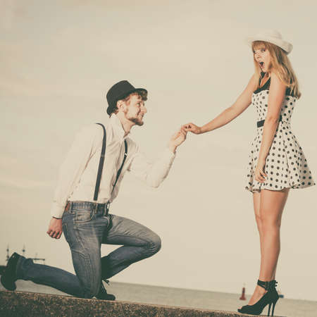 Summer holidays love relationship and dating concept - romantic playful couple retro style flirting on sea shoreの写真素材