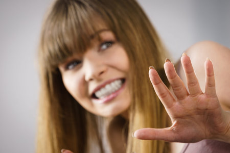 Woman being uncertainty skeptical questioning something and gesturing with one hand. Studio shot on...