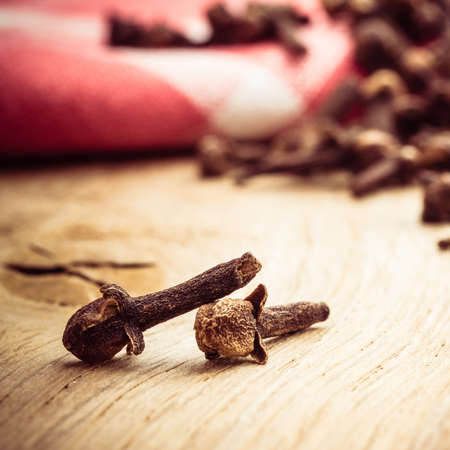 Spice dry cloves heap on kitchen table wooden surfaceの写真素材