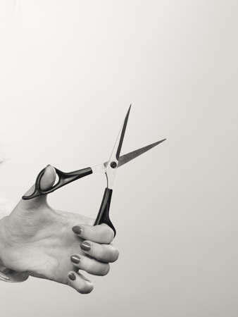 Equipment of barber. Hand of female hairdresser hairstylist with scissors trimmers. Time to cut hair.の写真素材