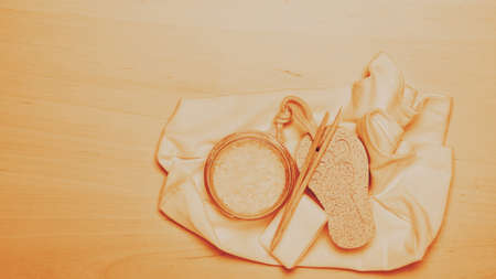 Foot care. Pedicure accessories set tools on wooden board background top view with copy spaceの写真素材