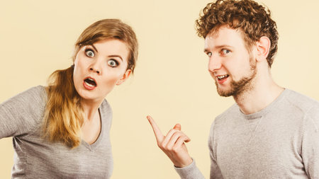 Problems in relationship. Young blonde couple arguing and yelling on each other. Emotional way to...