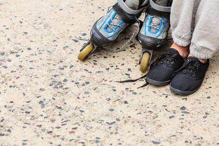 Closeup of woman girl with roller skates blades outdoor.の写真素材
