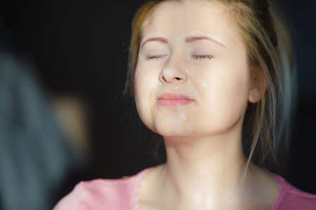 Facial dry skin and body care, complexion treatment at home concept. Young woman having gel peel off mask on her face.の写真素材