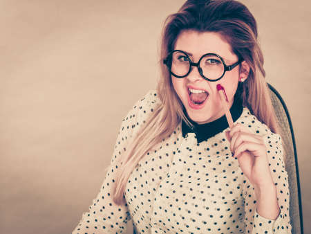 Coquet attractive blonde business woman flirting working. Love romance at work concept.の写真素材