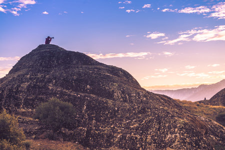 Tourism vacation and travel. Female tourist taking photo with camera from mountains and cliffs over...