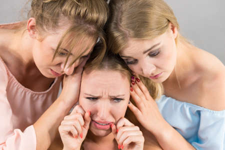 Female women comforting her woman sad friend helping her dealing with problems.の写真素材