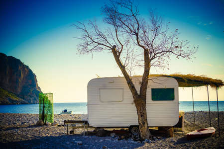 Tourism vacation and travel. Caravan trailer on sunny beach in Greeceの写真素材