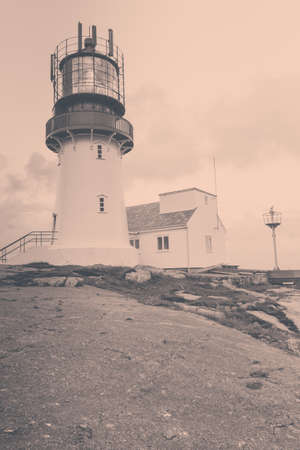 Historic lighthouse on the edge of rocky sea coast, South Norway, Lindesnes Fyr beaconの写真素材