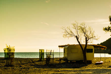 Tourism vacation and travel. Caravan trailer on sunny beach in Greeceの写真素材