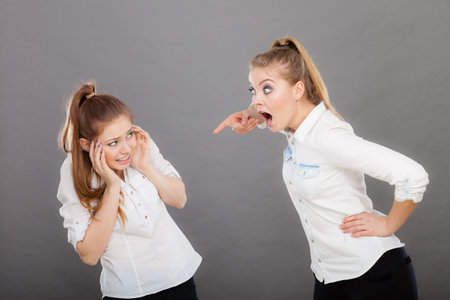 Conflict, bad relationships, friendship difficulties. Two young women having argument. Angry fury...