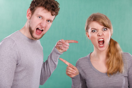 Bad relationship and divorce. Expressive young couple yelling shouting. Husband and wife having big...