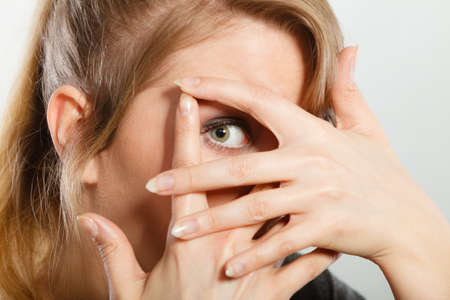 Fear and scare. Violence against woman. Concept of threating young terryfying girl. Scared frightened female making hands gesture to defend herself.の写真素材