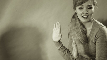 Violence against woman. Scared afraid woman. Negative relations in partnership. Expressive young...
