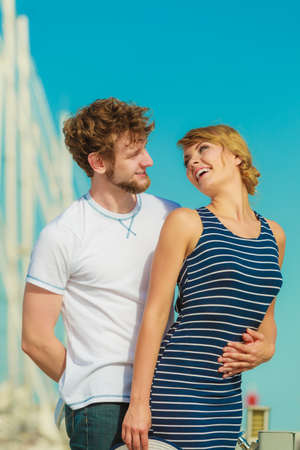 Travel tourism and people concept. Young tourist couple on vacation standing in front of boats in marinaの写真素材