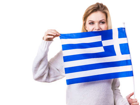 Happy funny woman holding Greece greek national flag being patriotic loving her country.の写真素材