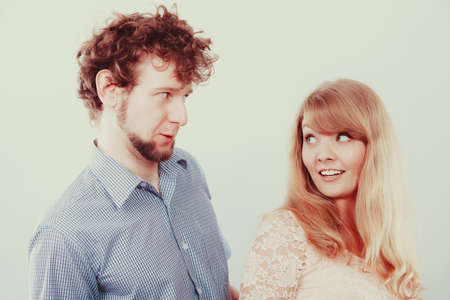 Happy romantic young couple. Smiling friends woman and man in studio.の写真素材