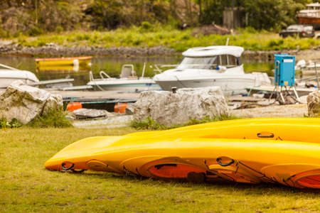 Active lifestyle sport concept. Many yellow canoes outdoor in rental center.の写真素材