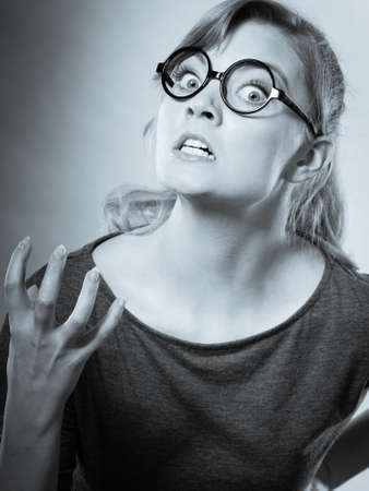 Wrath frustration emotions feelings mental disorder concept. Nerdy girl pissed off. Frustrated lady in glasses expressing anger.の写真素材