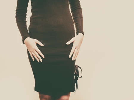 Unrecognizable woman wearing elegant short dress or skirt. Fashionable female presenting outfit.の写真素材