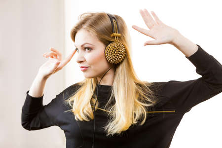 Teenager young grunge woman wearing black and listening to music on headphones with spikesの写真素材