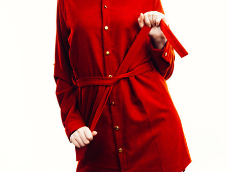Fashionable pretty woman wearing elegant casual red short dress presenting stylish outfit.