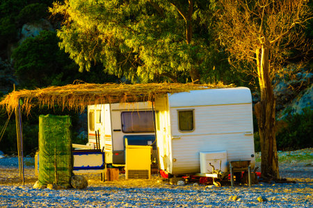 Tourism vacation and travel. Caravan trailer on sunny beach in Greece