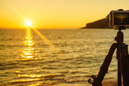 Professional camera taking picture film video of sunset over sea surface, Greece Peloponneseの写真素材