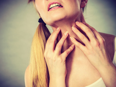 Health problem, skin diseases. Young woman scratching her itchy neck with allergy rash
