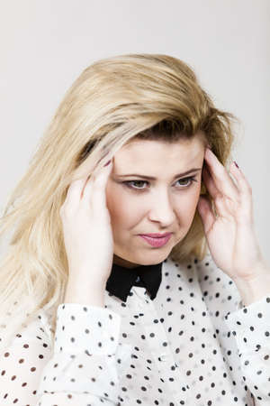 Business woman having bad headache feeling very unwell, being tired in pain.の写真素材