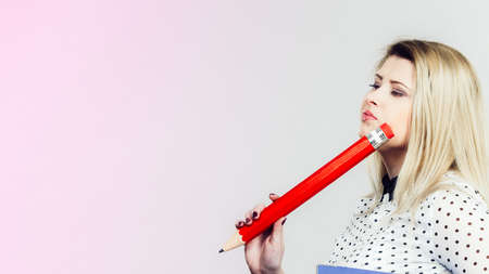 Woman hand holding big pencil.の写真素材