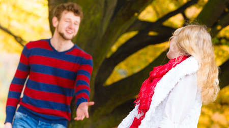Affection and feelings. Expressing positive emotions. Friendship and love. Young couple meet at autumnal park having fun on a romantic date.の写真素材