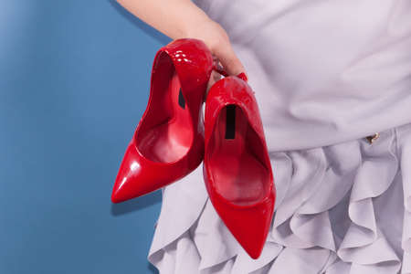 Woman hand fashion stylist presenting her elegant shoes.の写真素材