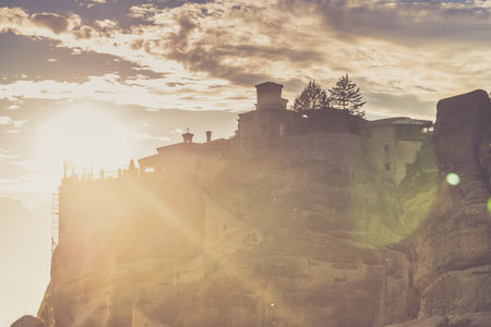 Scenic sunset evening sky over holy Varlaam monastery on cliff in Meteora, Thessaly Greece. Greek destinationsのeditorial素材
