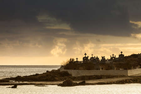Agios Fokas near Monemvasia in stormy weather overcast sky, sunrise. Small cemetery on sea shore, Maleas peninsula region Peloponneseのeditorial素材
