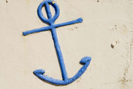 Blue anchor detail on light white wall. Close up of architecture decoration.の写真素材