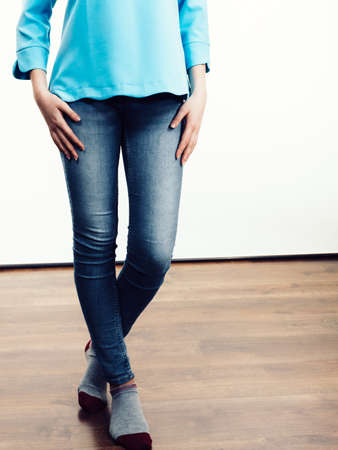 Unrecognizable woman presenting her casual beautiful outfit, long sleeved blue top and jeans.の写真素材
